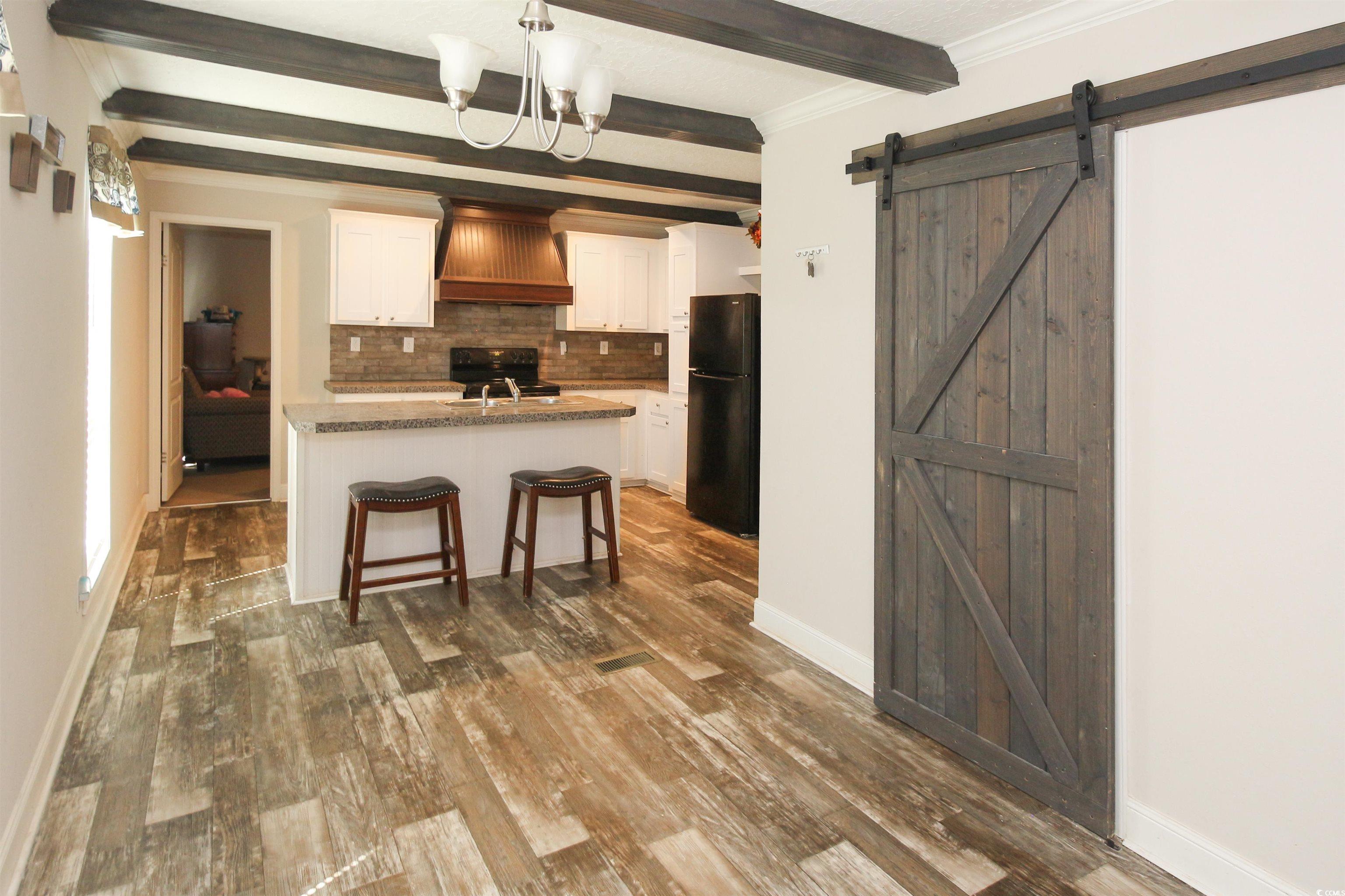 3605 Timber Lane Blenheim, SC 29516 - Photo 8 of 28 Kitchen with custom exhaust hood, black appliances