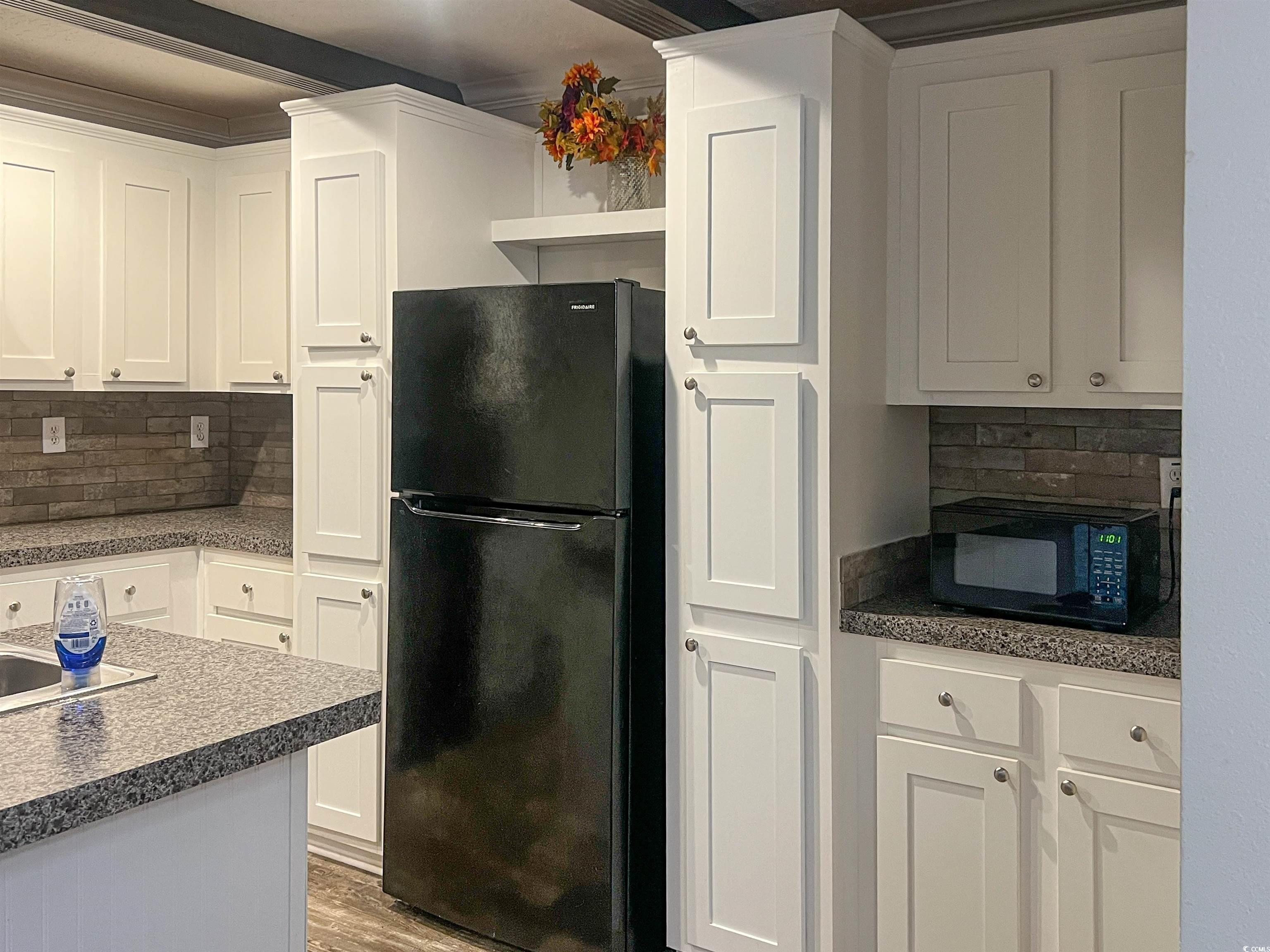 3605 Timber Lane Blenheim, SC 29516 - Photo 10 of 28 Kitchen featuring white cabinetry, backsplash, har