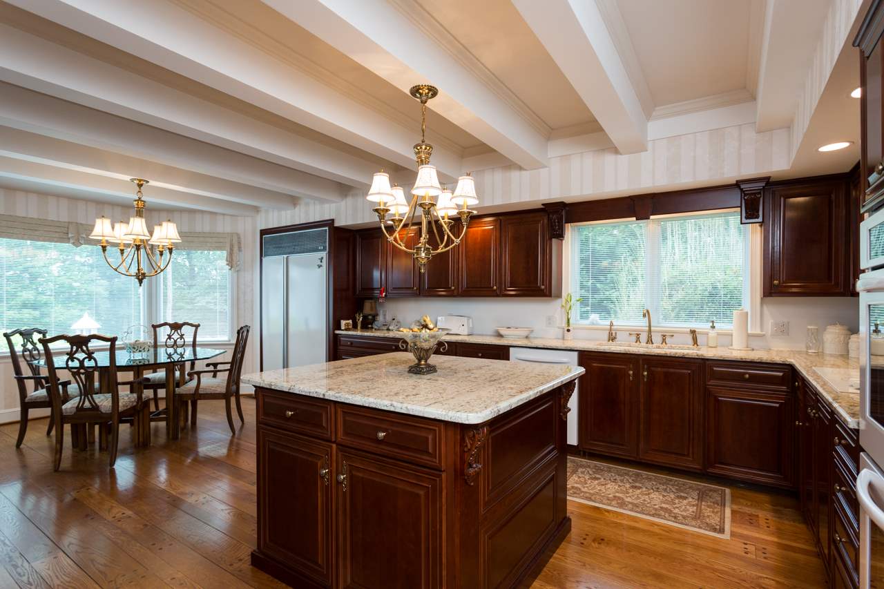 46 East Roman Ridge Road Mount Sidney, VA 24467 - Photo 3 of 50 a kitchen with a stove a sink dishwasher a dining table and chairs with wooden floor