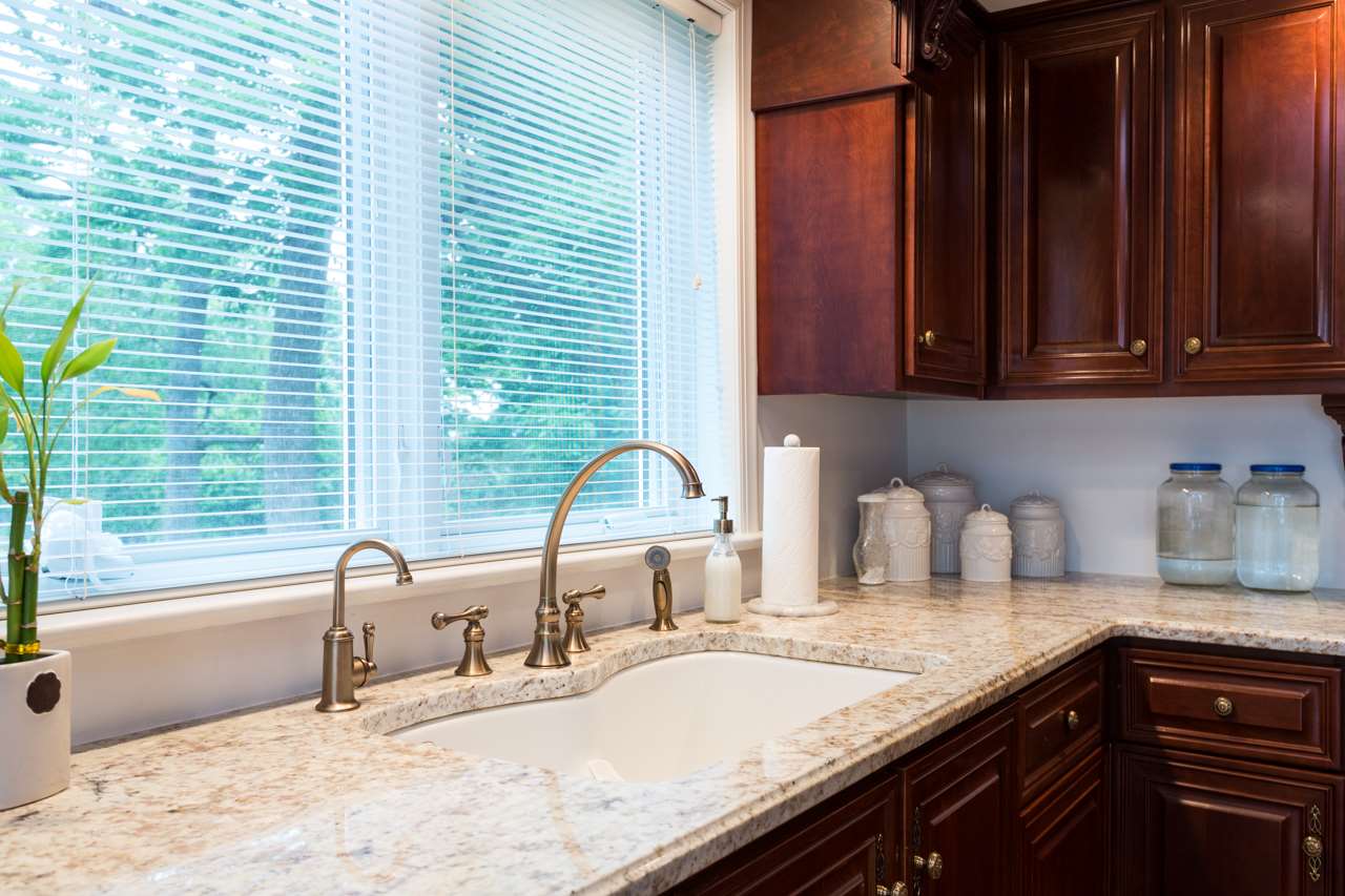 46 East Roman Ridge Road Mount Sidney, VA 24467 - Photo 8 of 50 a kitchen with granite countertop a sink and a wooden floor