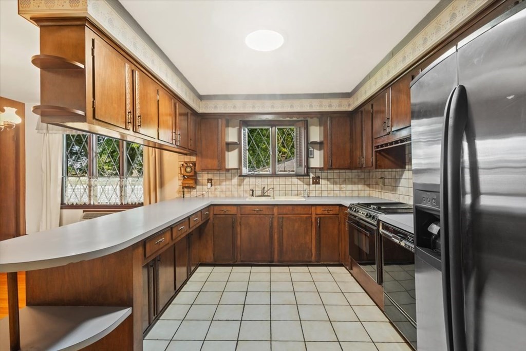 48 Kenyon Road Tiverton, RI 02878 - Photo 14 of 42 a kitchen with stainless steel appliances granite countertop a sink stove and refrigerator