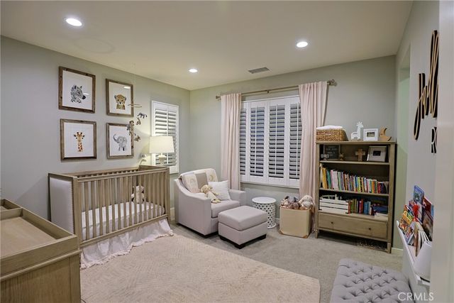 a bedroom with furniture and a book shelf
