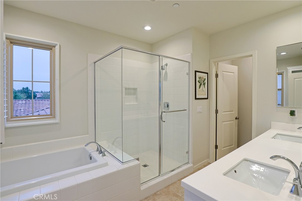 78 Kestrel Irvine, CA 92618 - Photo 16 of 32 a bathroom with a tub a sink and mirrors