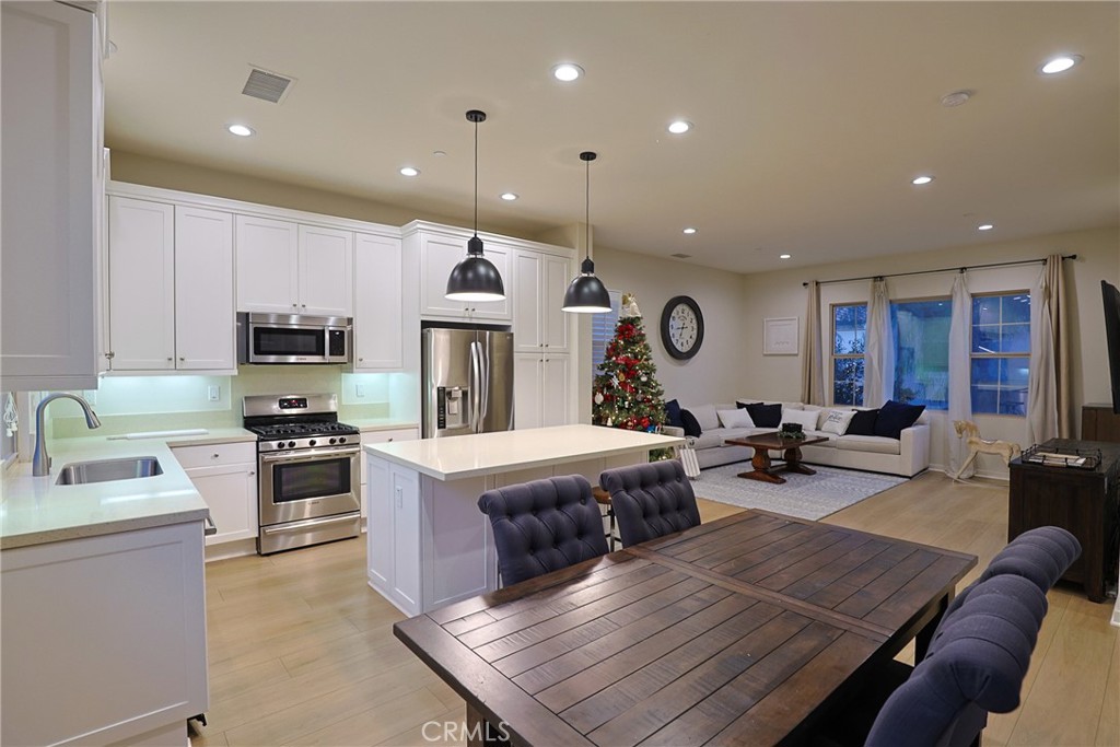 78 Kestrel Irvine, CA 92618 - Photo 6 of 32 a living room with stainless steel appliances furniture or couch and a kitchen view