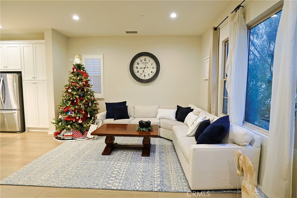 78 Kestrel Irvine, CA 92618 - Photo 10 of 32 a living room with furniture and a chandelier