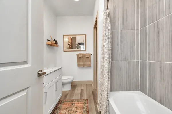a bathroom with a sink a toilet and shower curtain