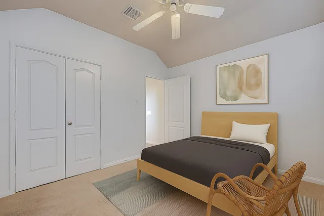 a bedroom with bed and a chandelier