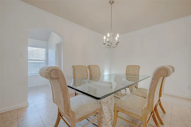a dining room with furniture and chandelier