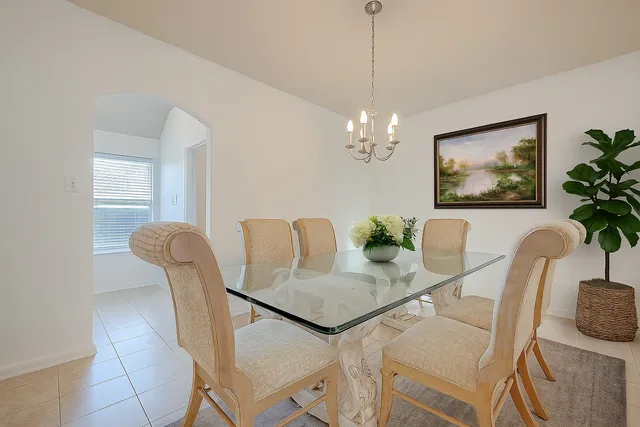 a view of a dining room with furniture and chandelier