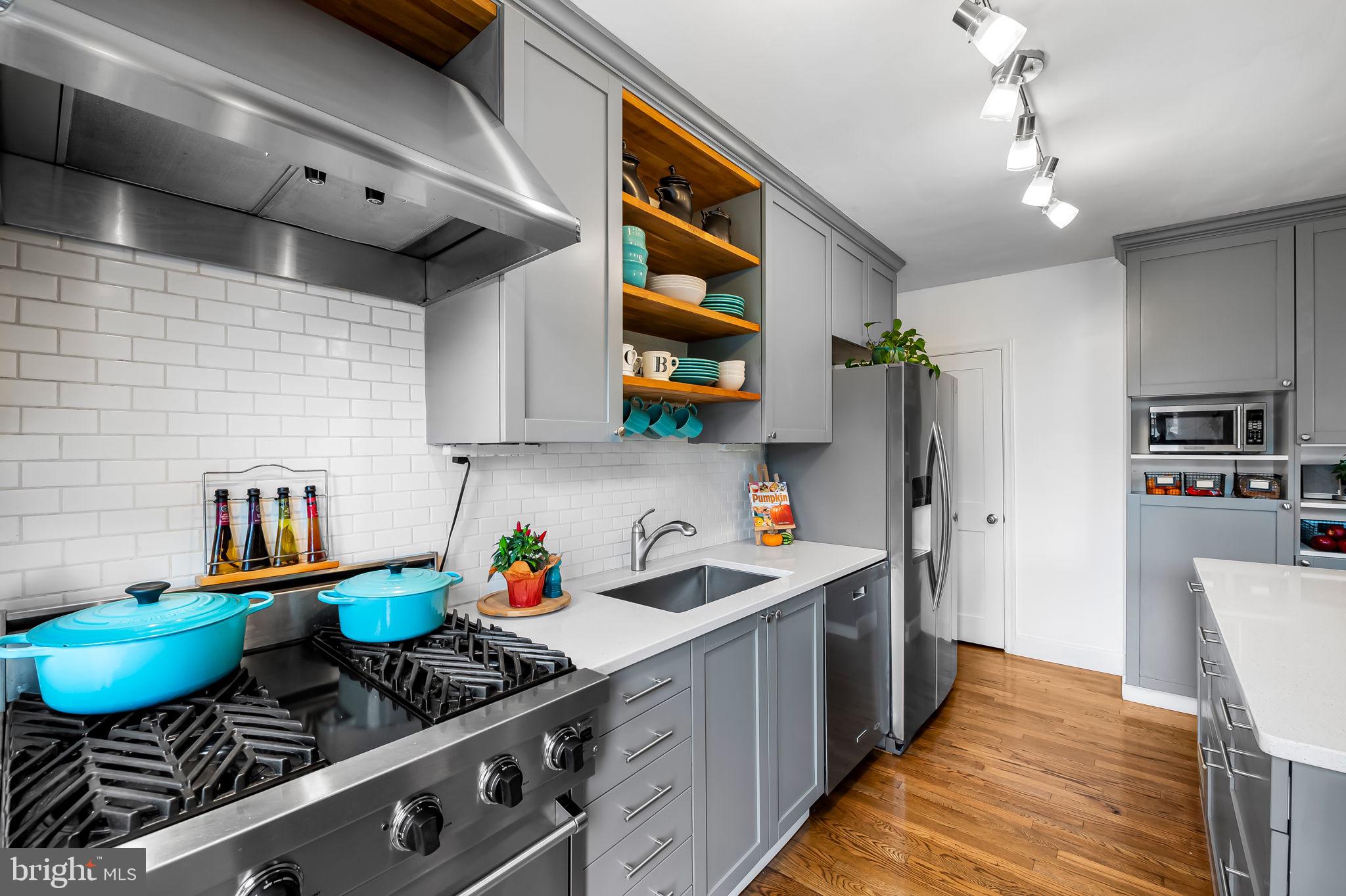 112 Regester Avenue Baltimore, MD 21212 - Photo 13 of 36 a kitchen with stainless steel appliances a sink stove and cabinets