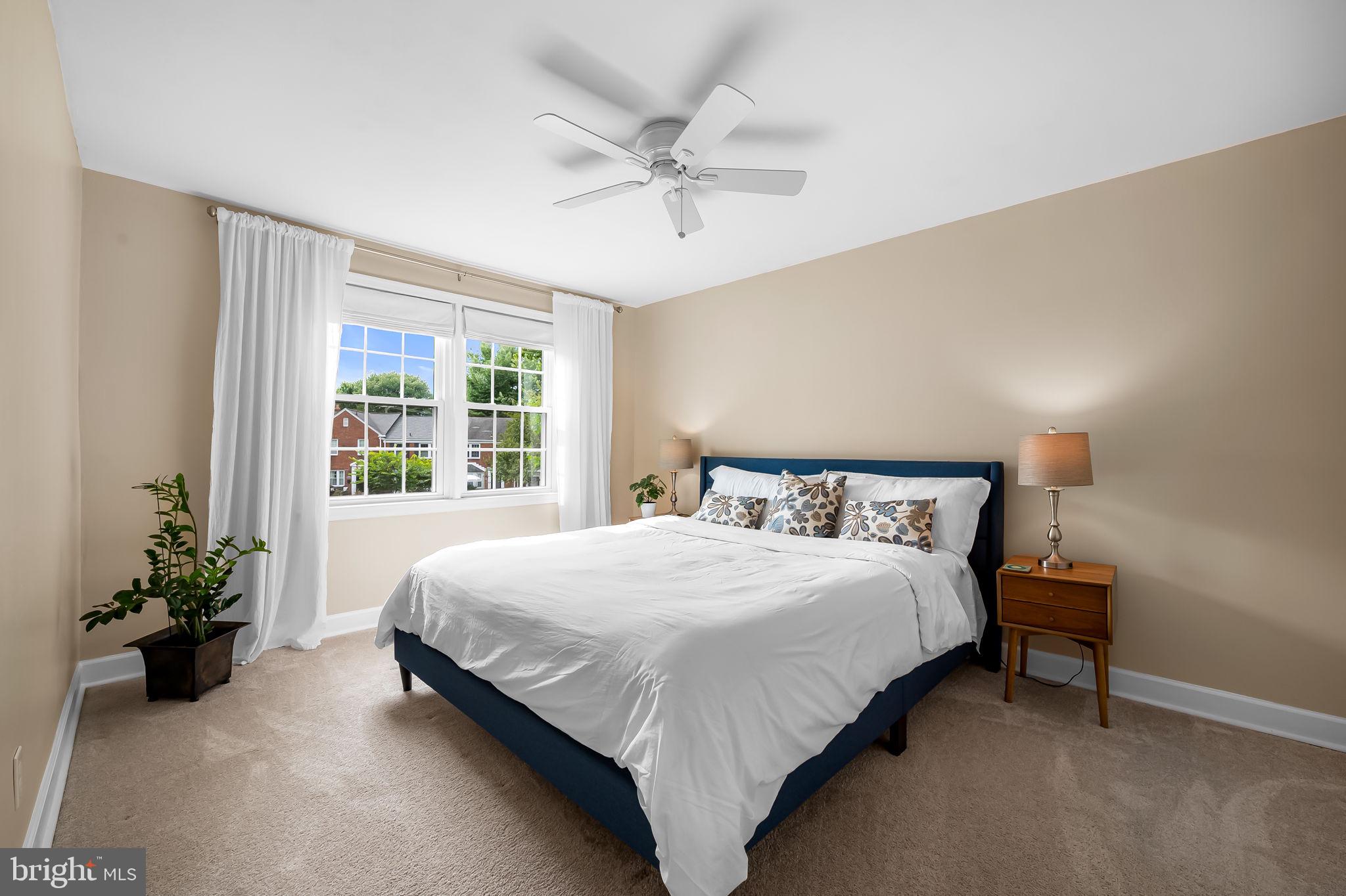 112 Regester Avenue Baltimore, MD 21212 - Photo 20 of 36 a bedroom with a bed and a chandelier