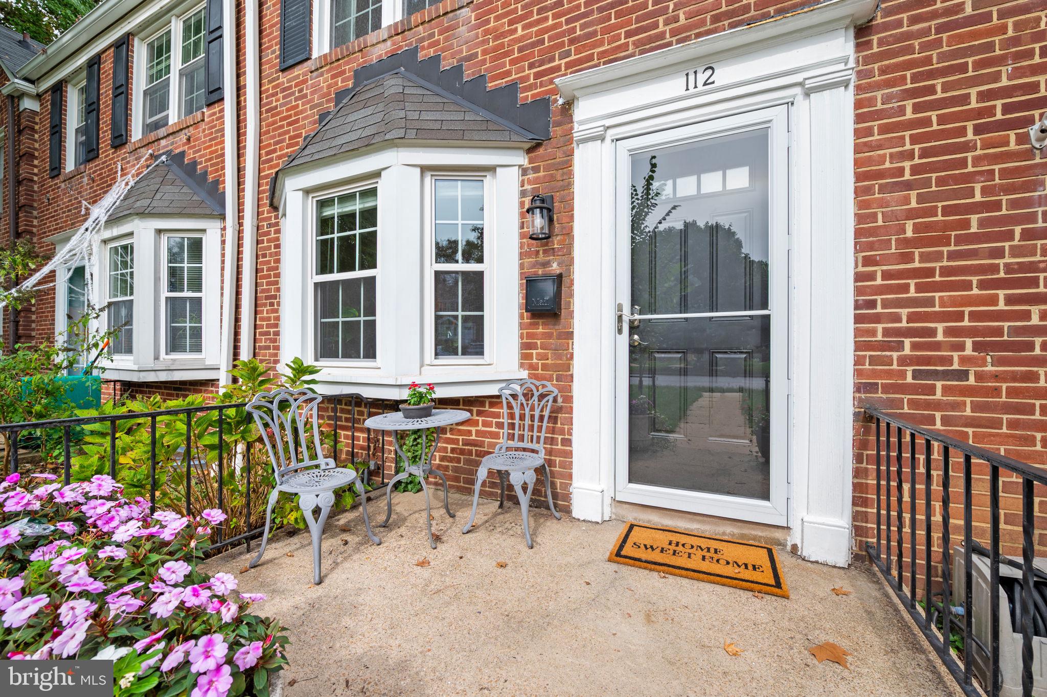 112 Regester Avenue Baltimore, MD 21212 - Photo 2 of 36 a view of brick house with a bench and table and chair