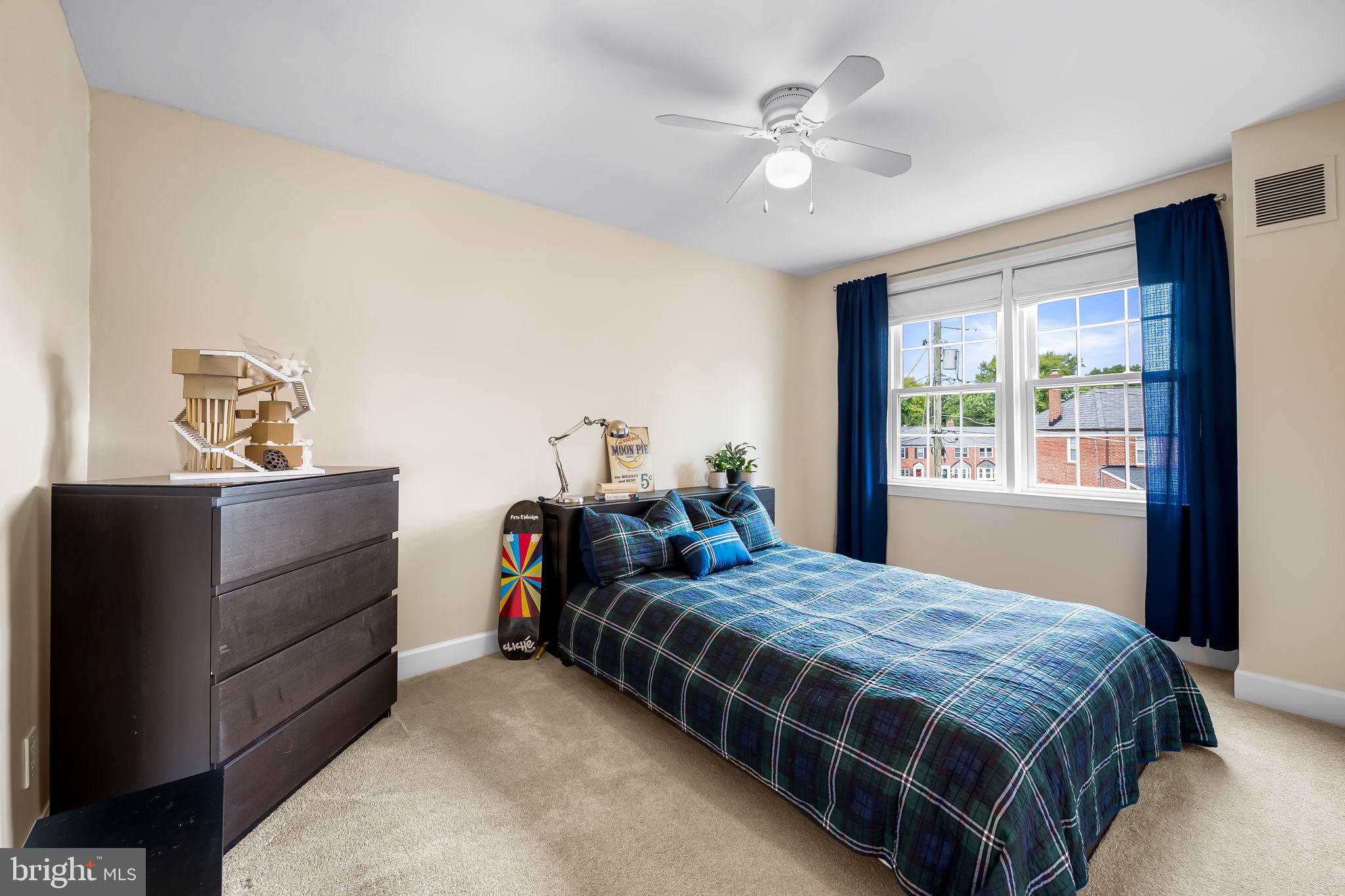 112 Regester Avenue Baltimore, MD 21212 - Photo 25 of 36 a bedroom with a bed and a chandelier