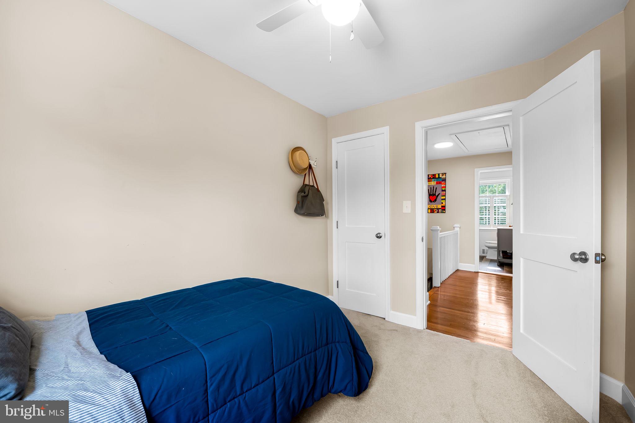 112 Regester Avenue Baltimore, MD 21212 - Photo 27 of 36 a bedroom with a bed and a chandelier