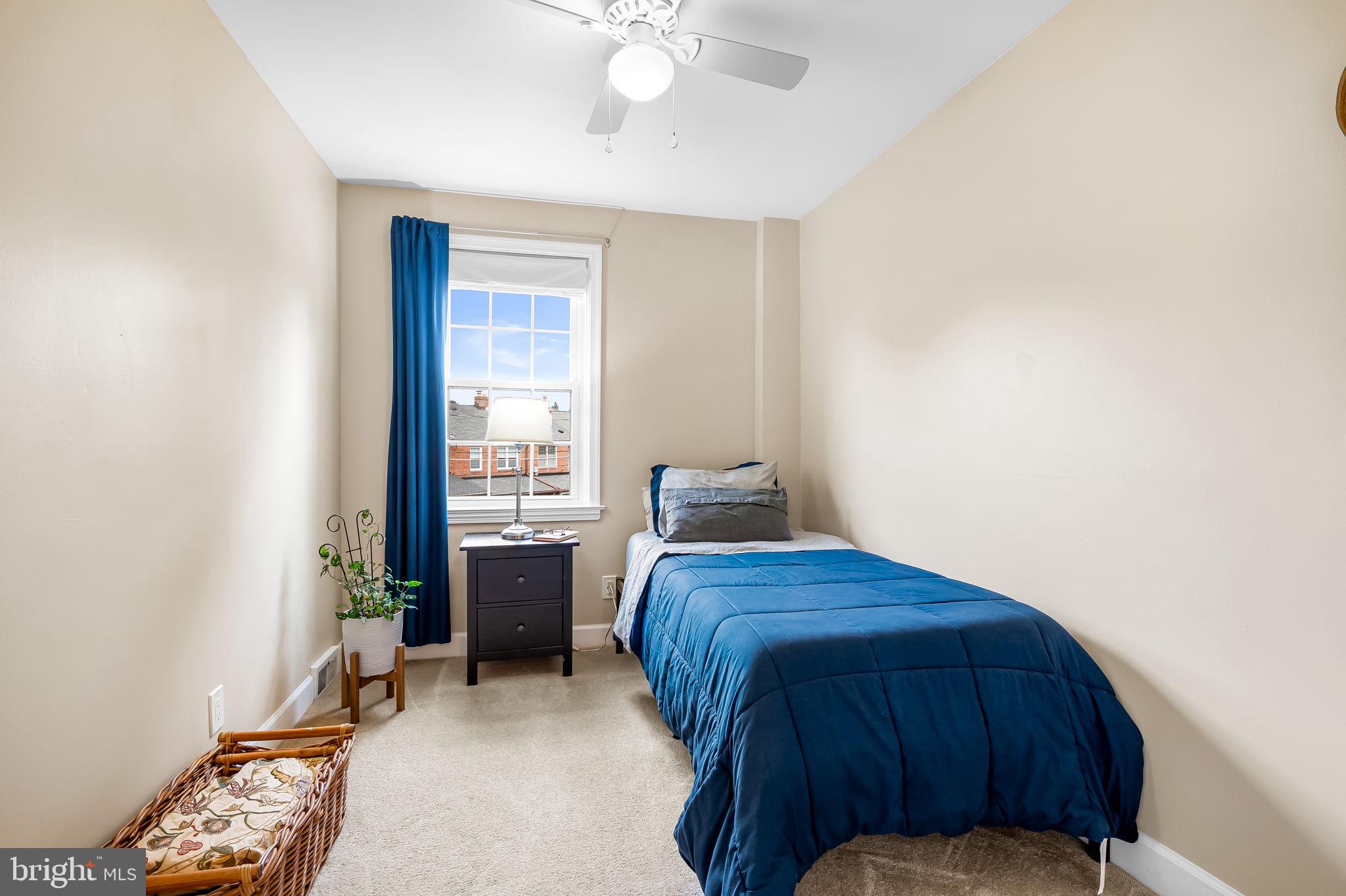 112 Regester Avenue Baltimore, MD 21212 - Photo 28 of 36 a bedroom with a bed and a window