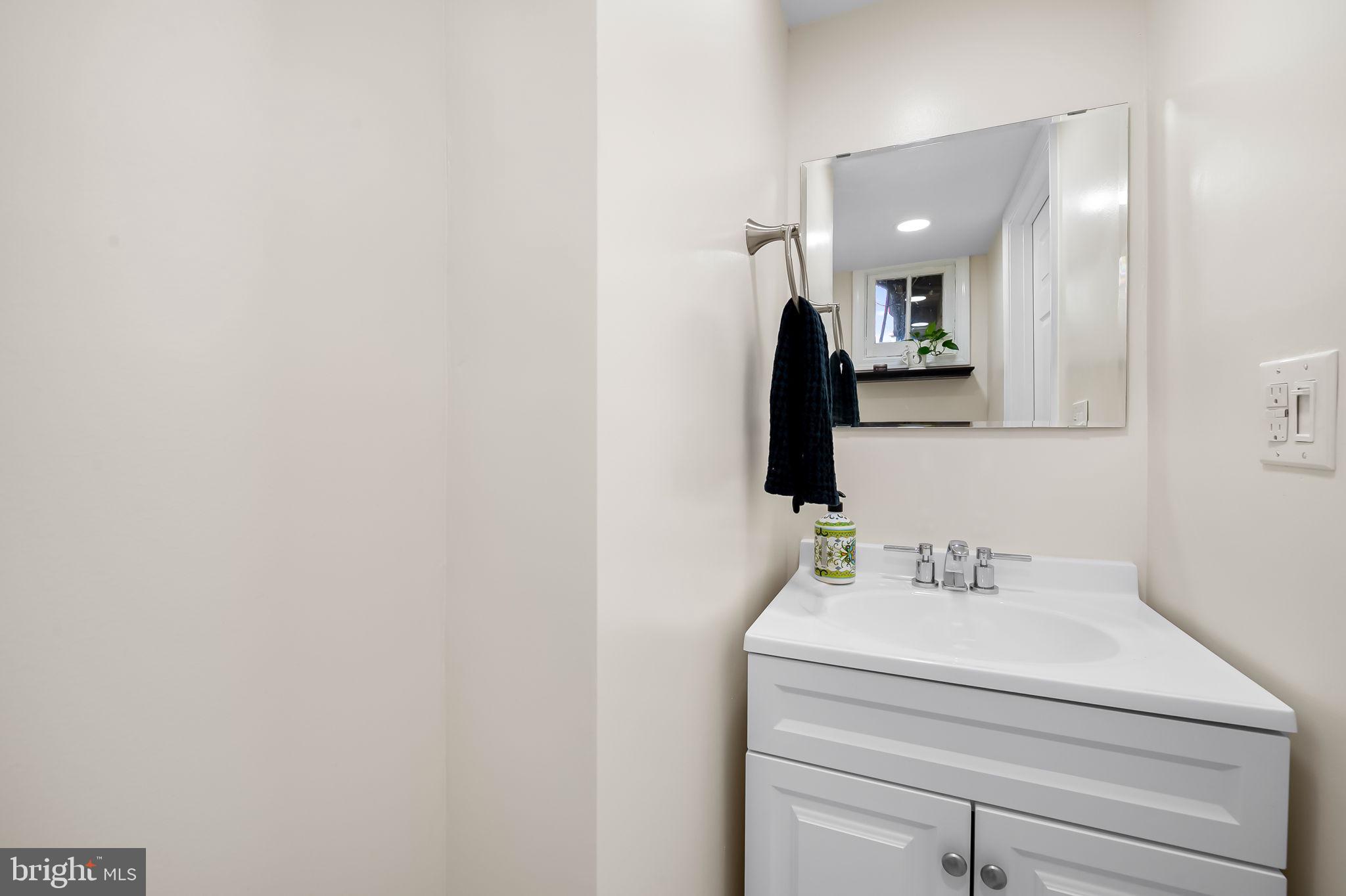 112 Regester Avenue Baltimore, MD 21212 - Photo 32 of 36 a bathroom with a sink and a mirror