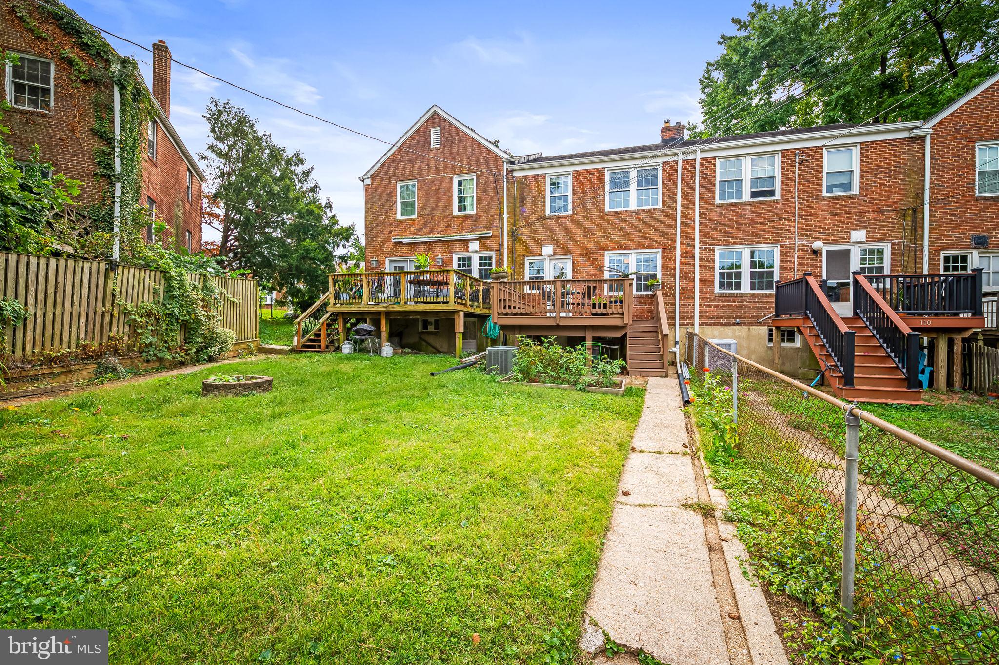 112 Regester Avenue Baltimore, MD 21212 - Photo 35 of 36 a front view of a house with a yard table and chairs