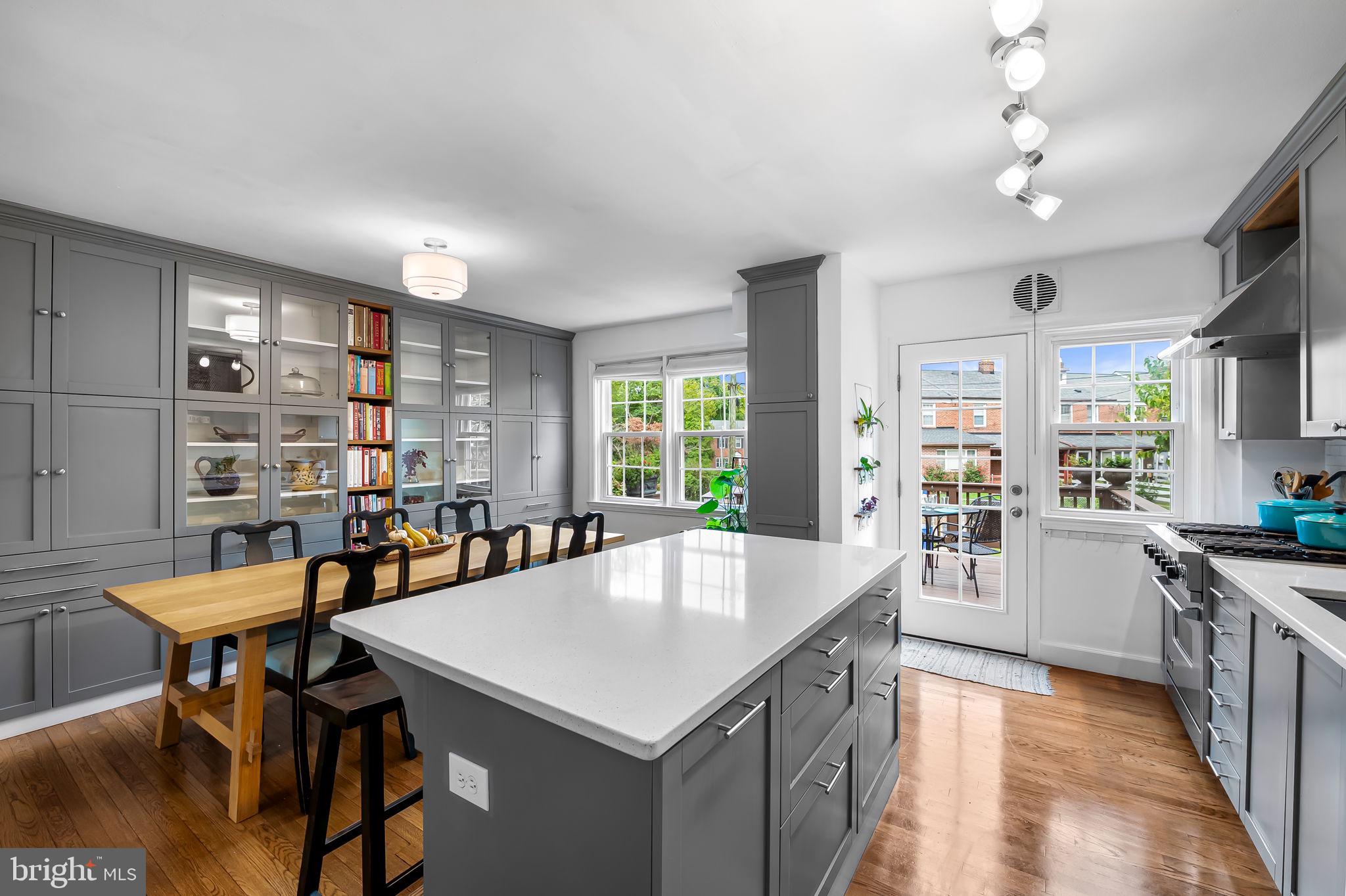 112 Regester Avenue Baltimore, MD 21212 - Photo 7 of 36 a kitchen with a table chairs and wooden floor