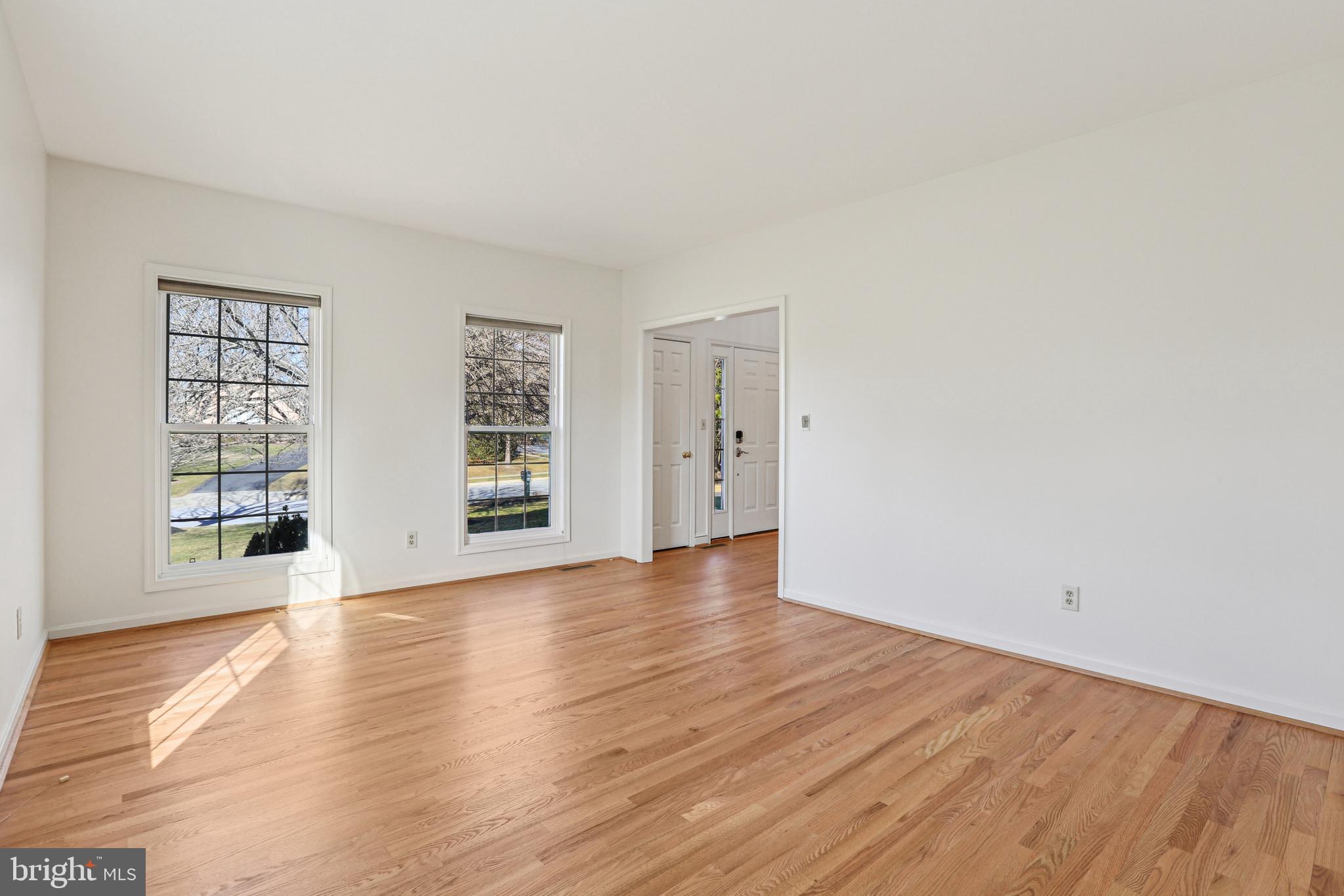 3924 Paul Mill Road Ellicott City, MD 21042 - Photo 26 of 51 a view of an empty room with wooden floor and windows