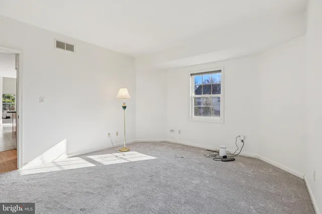 a view of a room with rack on the wall and a window