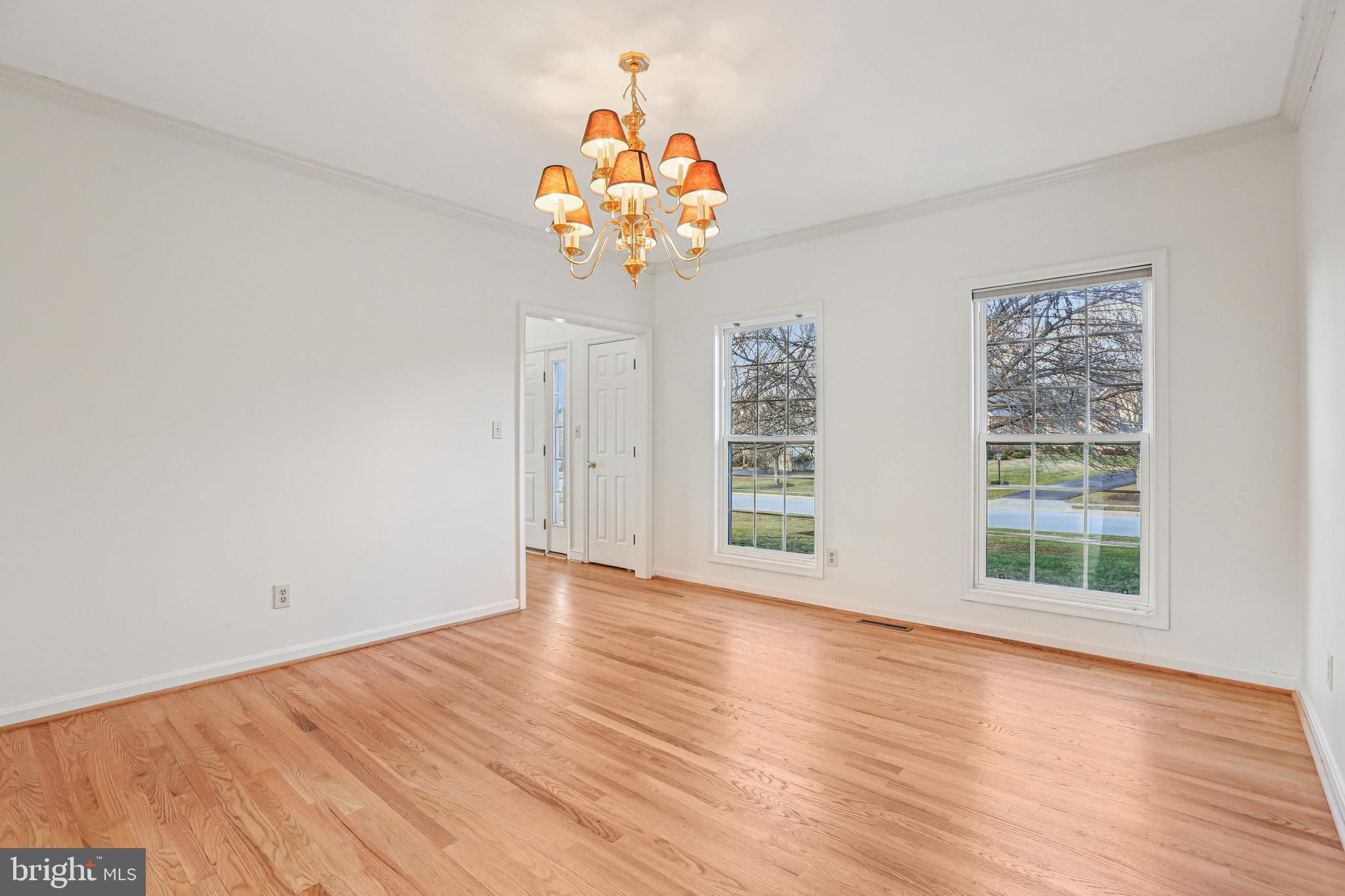 3924 Paul Mill Road Ellicott City, MD 21042 - Photo 32 of 51 an empty room with wooden floor and windows