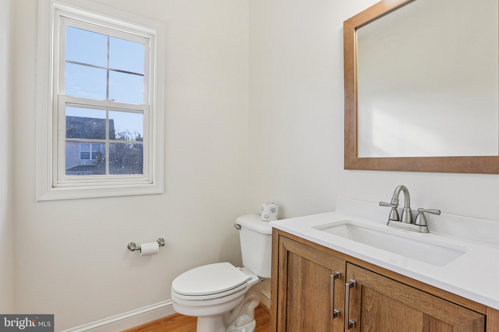 3924 Paul Mill Road Ellicott City, MD 21042 - Photo 33 of 51 a bathroom with a sink a toilet and a mirror