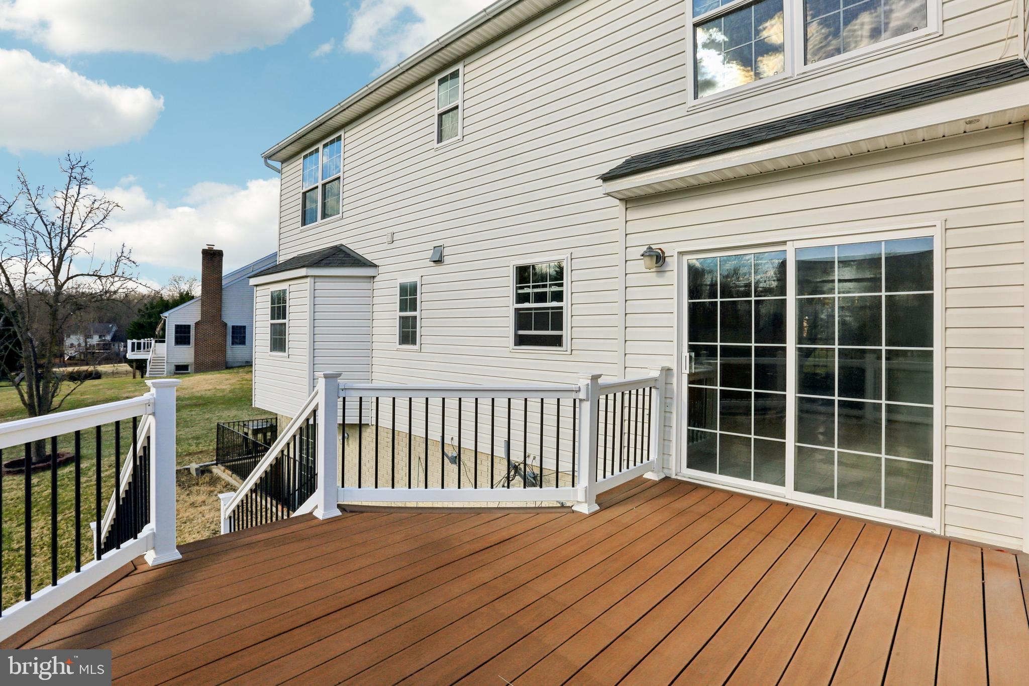 3924 Paul Mill Road Ellicott City, MD 21042 - Photo 47 of 51 a view of a house with a wooden deck