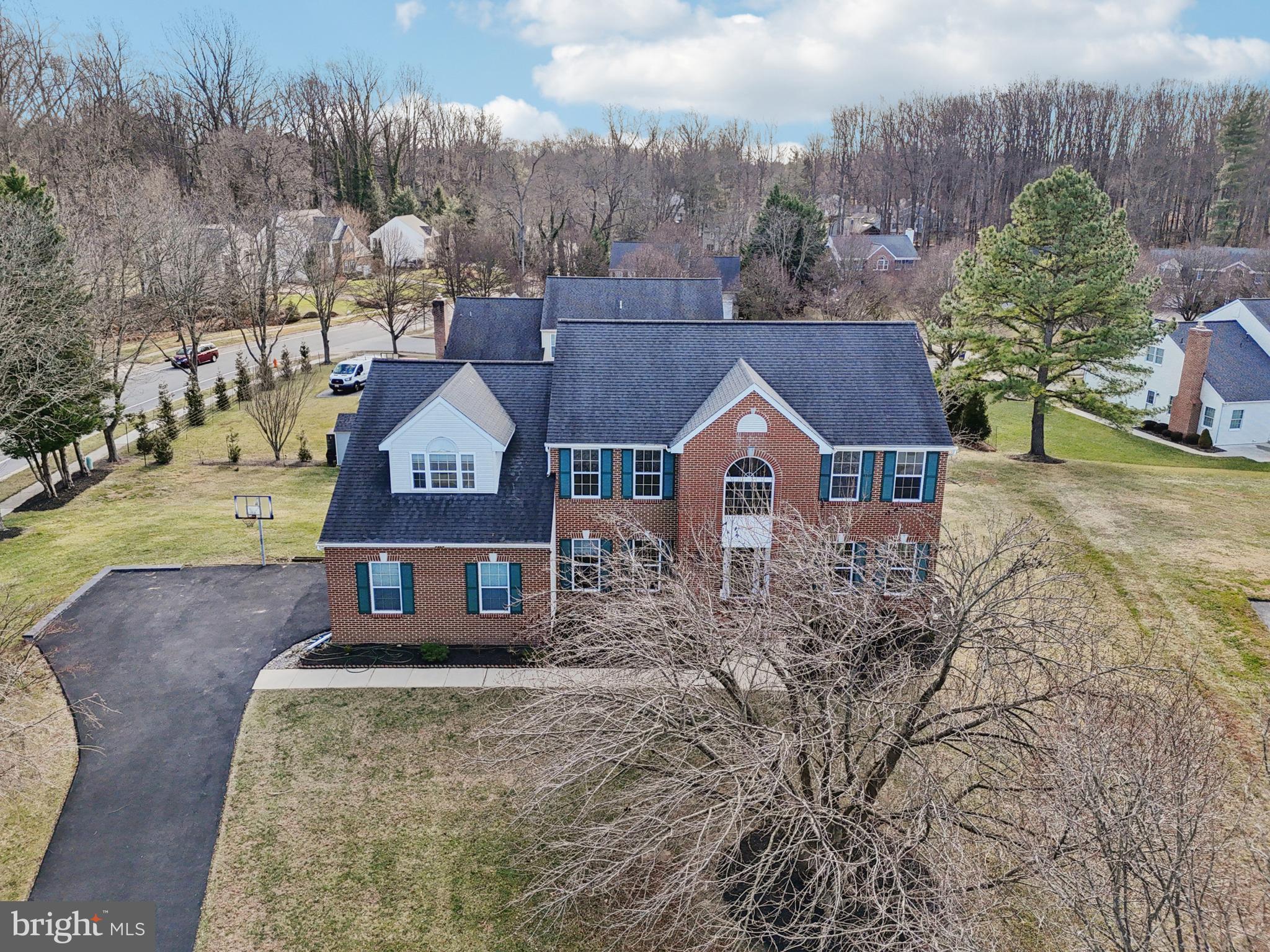 3924 Paul Mill Road Ellicott City, MD 21042 - Photo 49 of 51 a view of a house with a yard and trees