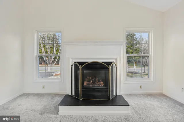 a living room with a fireplace and a window