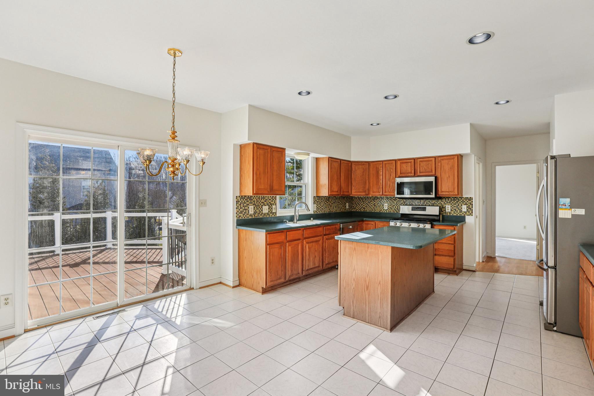 3924 Paul Mill Road Ellicott City, MD 21042 - Photo 6 of 51 a kitchen with stainless steel appliances kitchen island granite countertop a refrigerator a stove a sink and dishwasher
