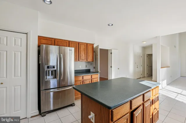 a kitchen with stainless steel appliances a refrigerator and a stove top oven