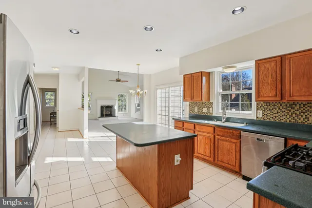 a kitchen with stainless steel appliances granite countertop a sink counter space and a stove