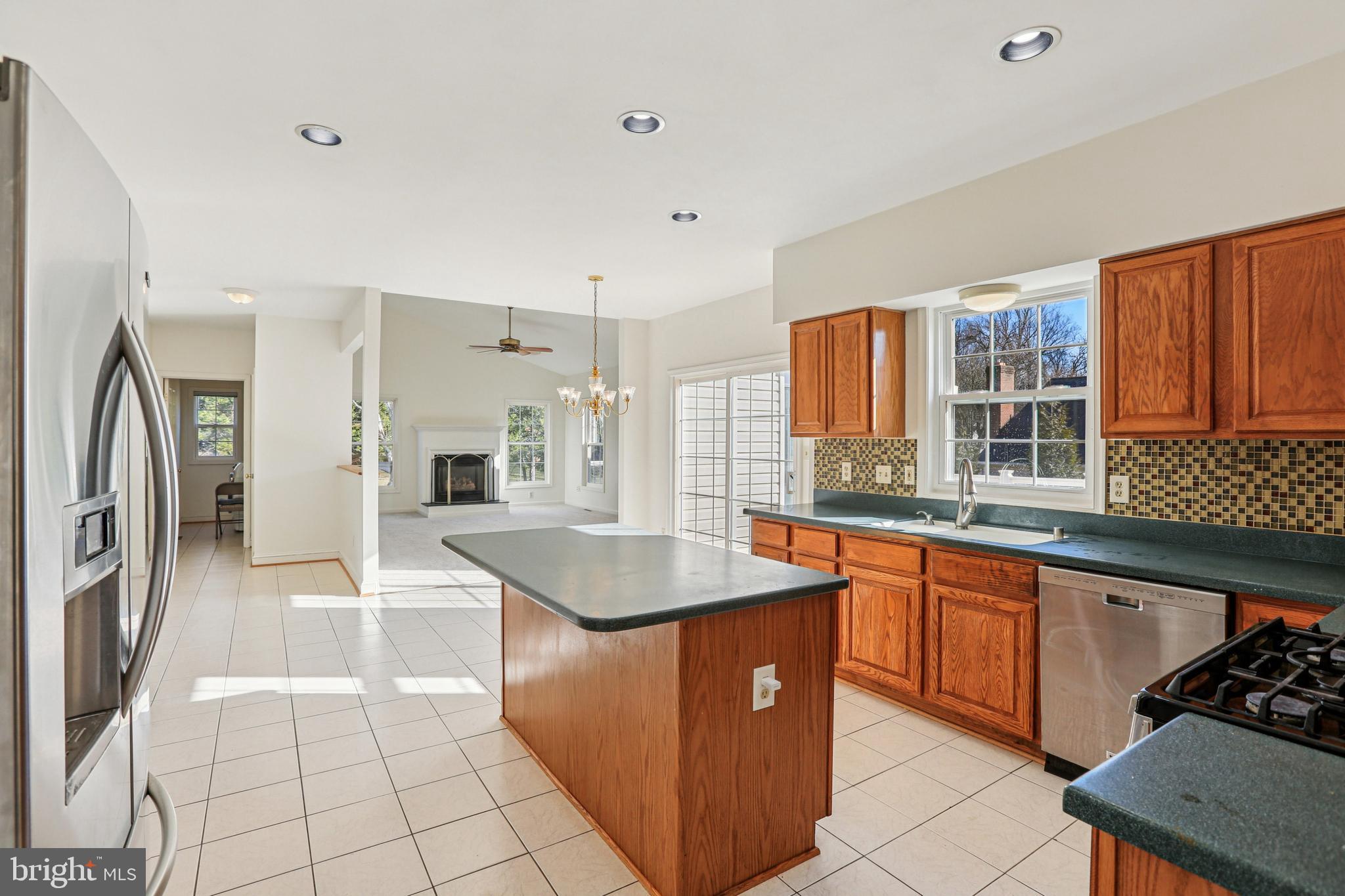 3924 Paul Mill Road Ellicott City, MD 21042 - Photo 10 of 51 a kitchen with stainless steel appliances granite countertop a sink counter space and a stove
