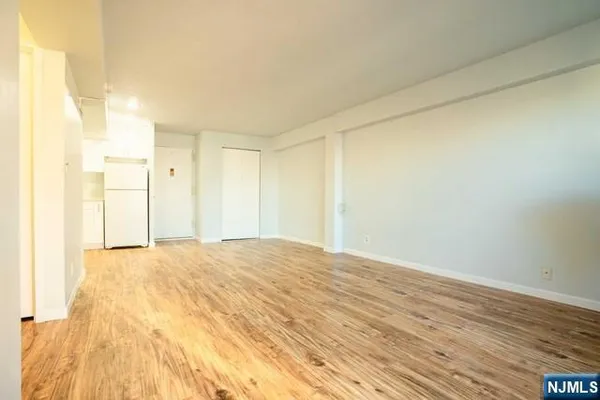 a view of an empty room and wooden floor