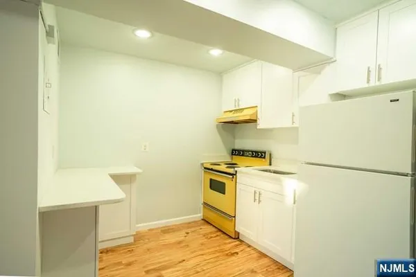a kitchen with a stove a refrigerator and a sink