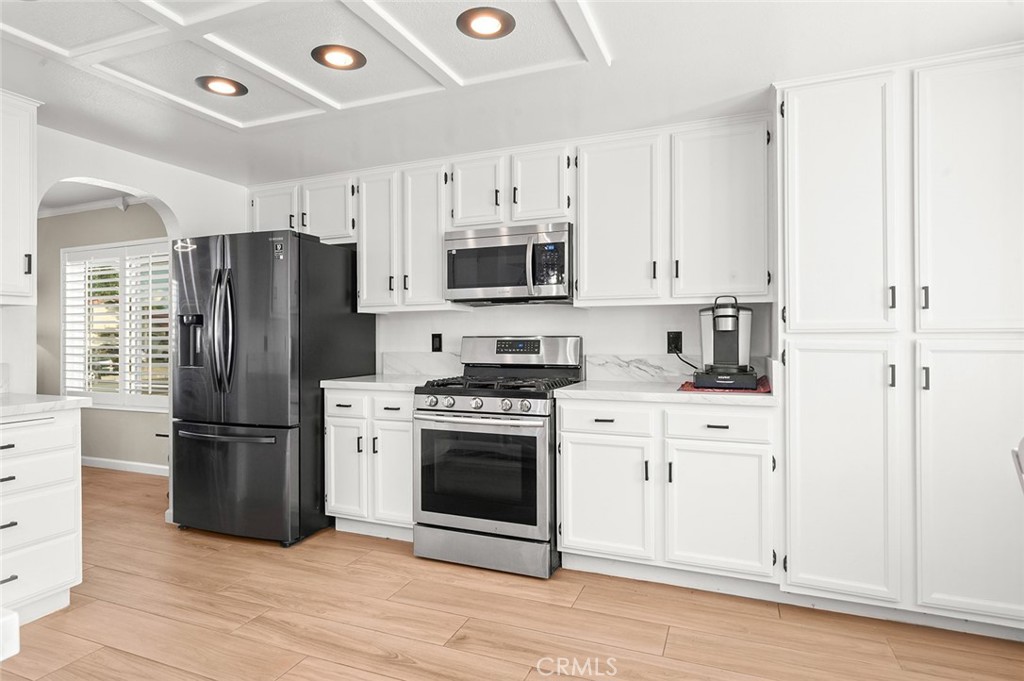 1790 North Encina Avenue Rialto, CA 92376 - Photo 15 of 47 a kitchen with stainless steel appliances a refrigerator stove and microwave