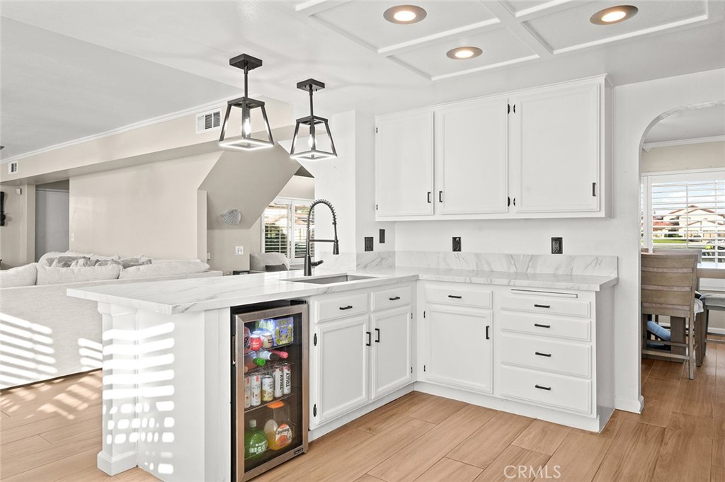 1790 North Encina Avenue Rialto, CA 92376 - Photo 16 of 47 a kitchen with cabinets appliances and a wooden floor
