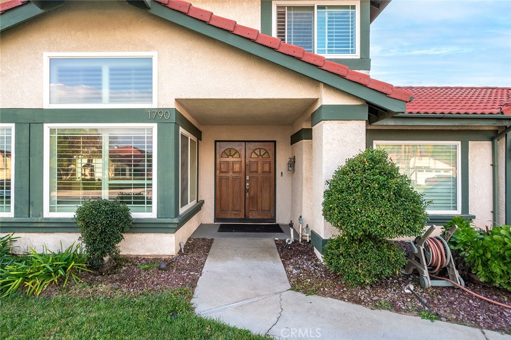 1790 North Encina Avenue Rialto, CA 92376 - Photo 2 of 47 a front view of a house with garden