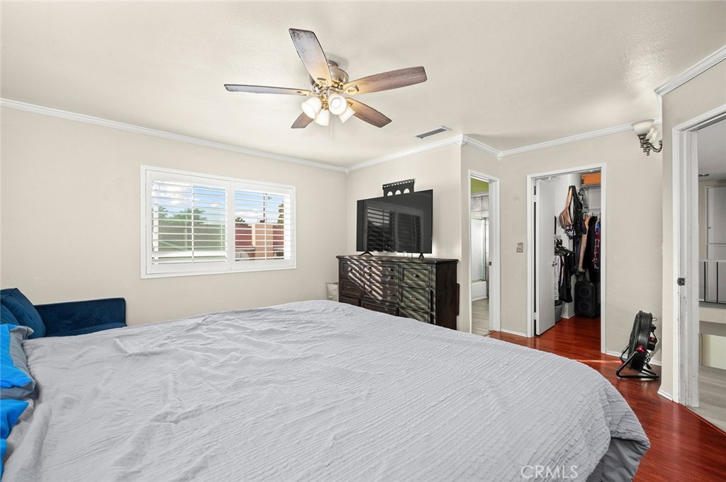 1790 North Encina Avenue Rialto, CA 92376 - Photo 22 of 47 a bedroom with a large bed and a chandelier