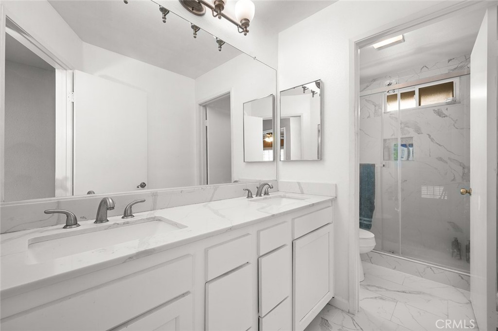 1790 North Encina Avenue Rialto, CA 92376 - Photo 26 of 47 a bathroom with a double vanity sink mirror and shower