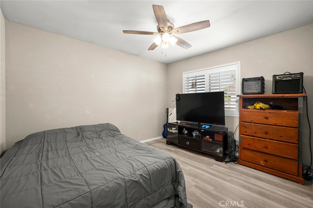 1790 North Encina Avenue Rialto, CA 92376 - Photo 30 of 47 a bedroom with a bed and a flat tv screen on wall