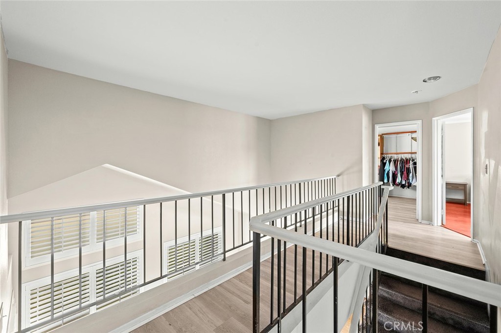 1790 North Encina Avenue Rialto, CA 92376 - Photo 32 of 47 a view of a hallway with wooden floor and windows