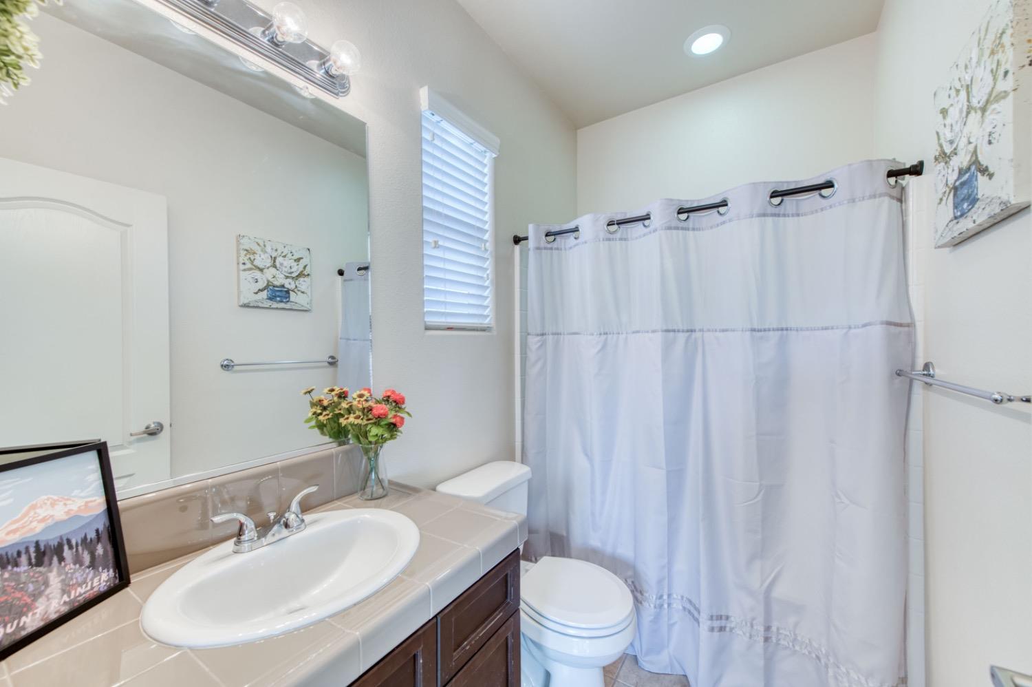 4085 Harlan Ranch Boulevard Clovis, CA 93619 - Photo 13 of 27 a bathroom with a sink toilet and shower