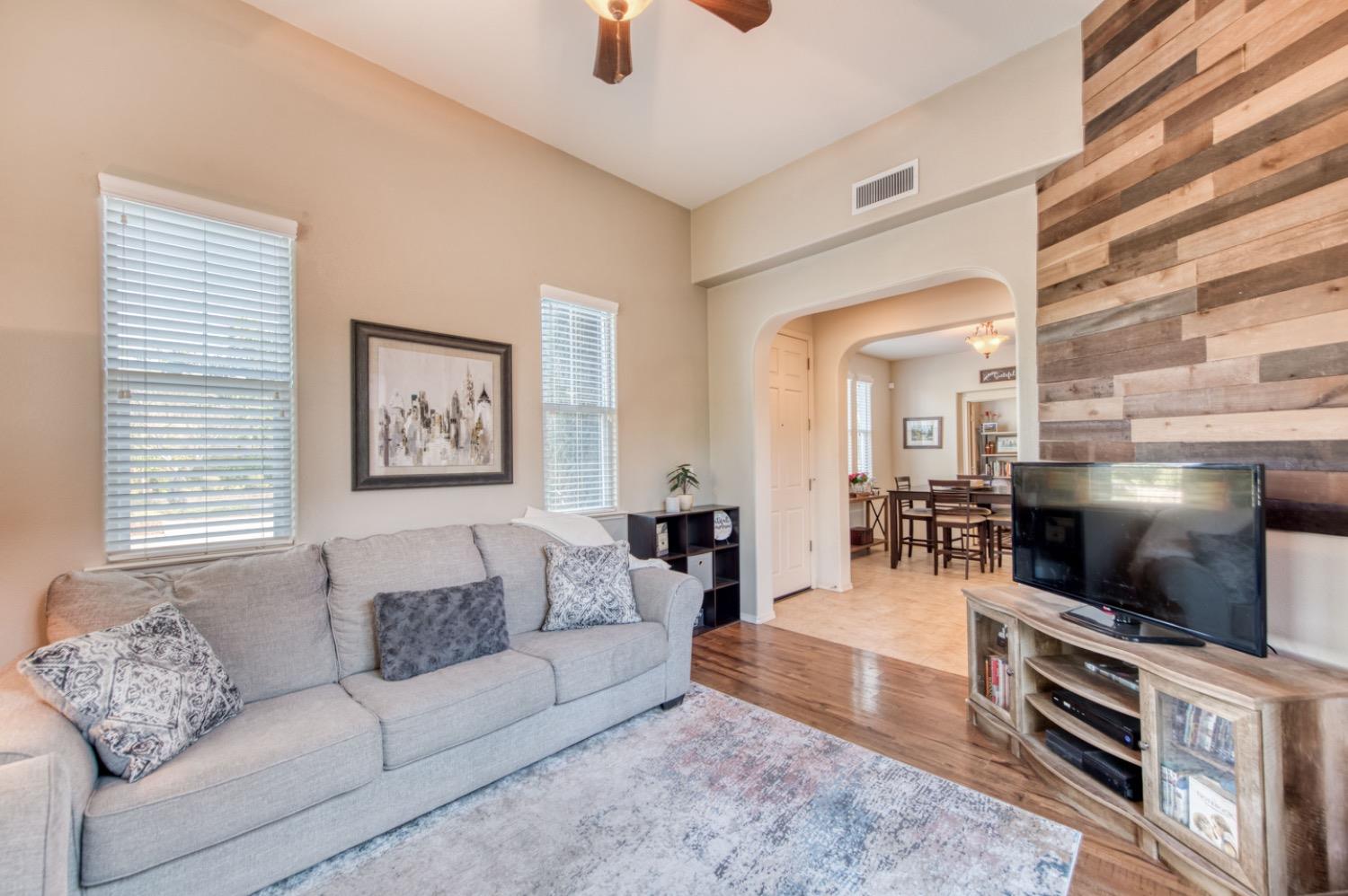 4085 Harlan Ranch Boulevard Clovis, CA 93619 - Photo 19 of 27 a living room with furniture and a flat screen tv