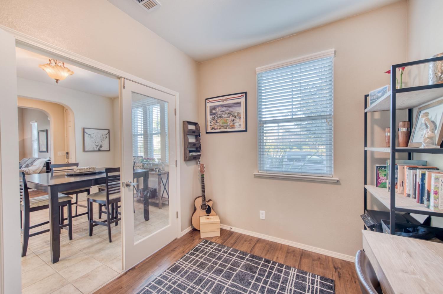 4085 Harlan Ranch Boulevard Clovis, CA 93619 - Photo 5 of 27 a view of a bedroom with workspace and a window