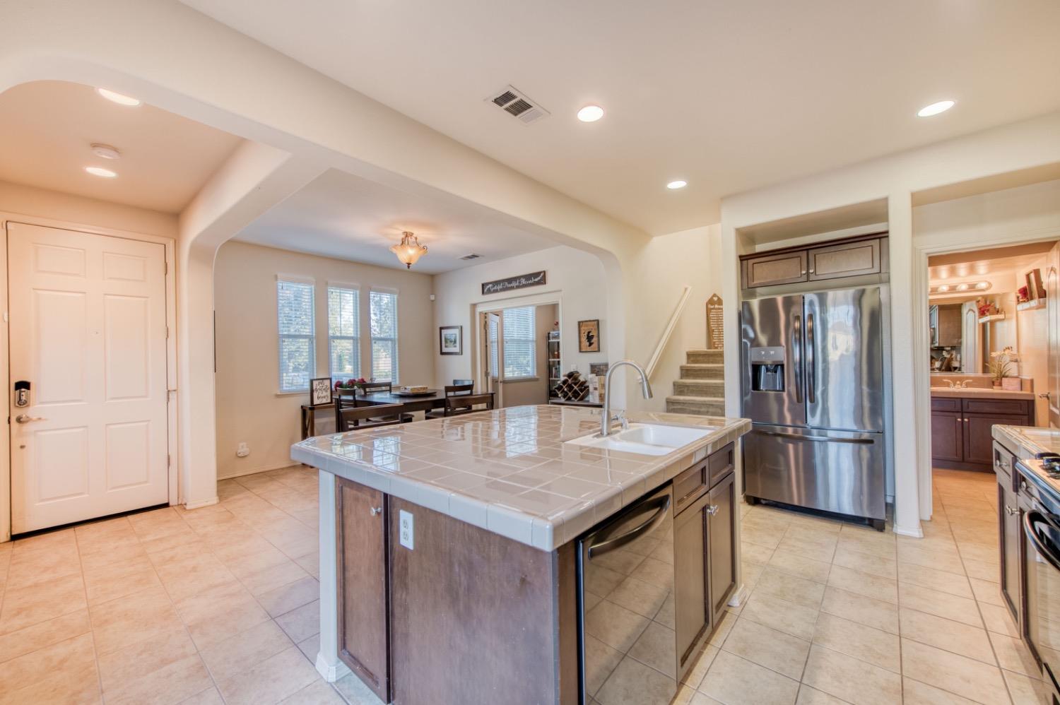 4085 Harlan Ranch Boulevard Clovis, CA 93619 - Photo 7 of 27 a kitchen with stainless steel appliances granite countertop a refrigerator and a sink
