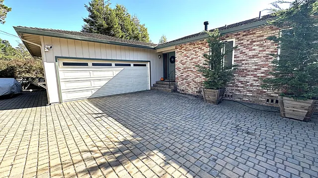 a view of a house with a backyard