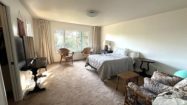 a bedroom with two beds and a couch