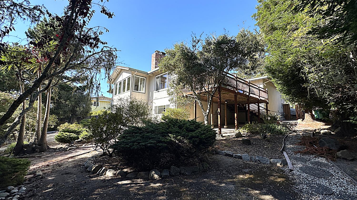 3076 Strawberry Hill Road Pebble Beach, CA 93953 - Photo 9 of 15 a view of a town with barn and large trees