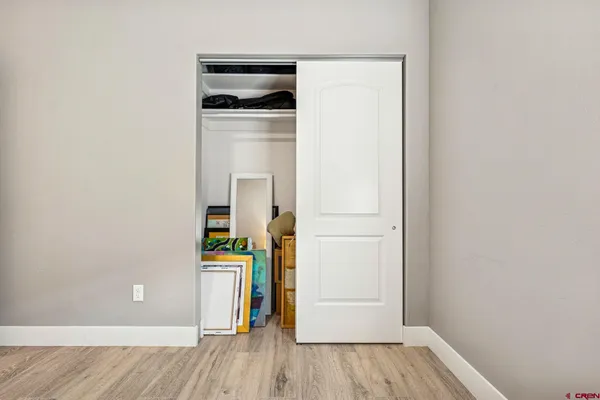 a view of empty room with wooden floor